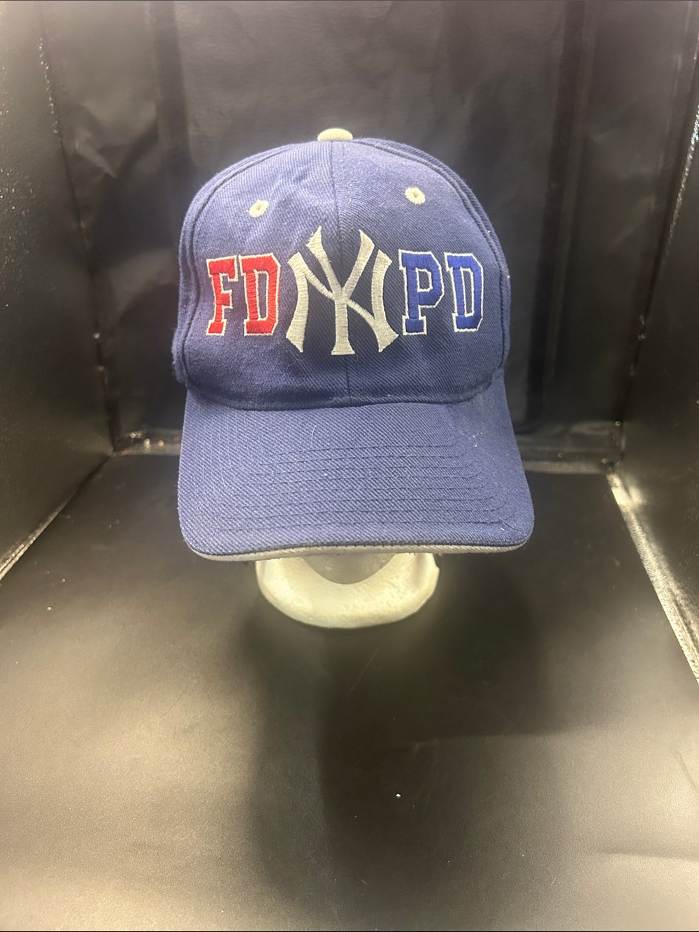 blue baseball hat features embroidered FDNY and NYPD lettering